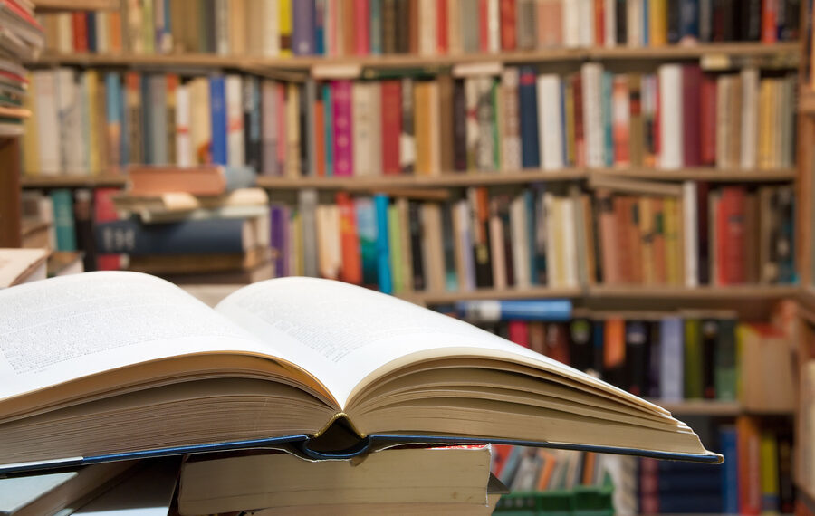 Old open book with a vintage library background